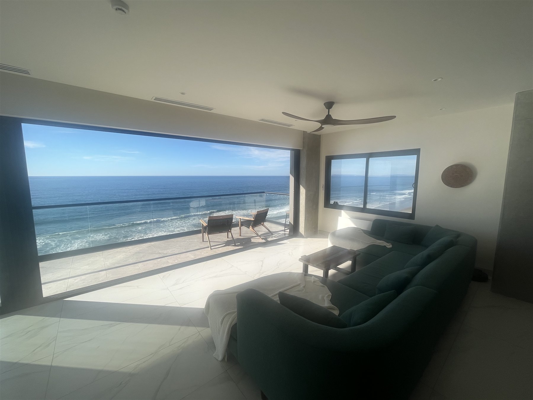Living room opening completely onto the oceanfront terrace