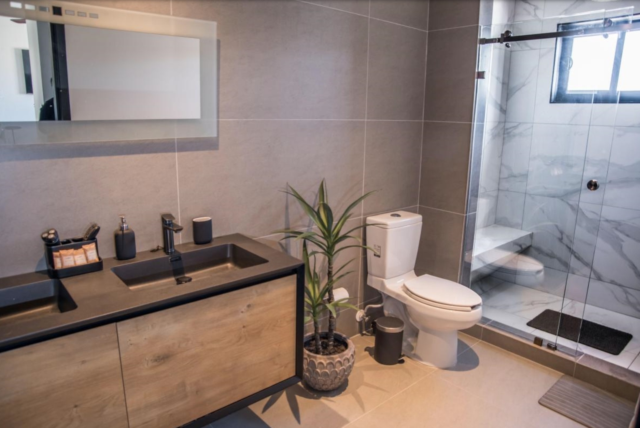 Primary bathroom with glass-enclosed marble shower
